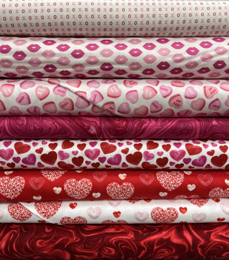 stack of folded valentine fabrics