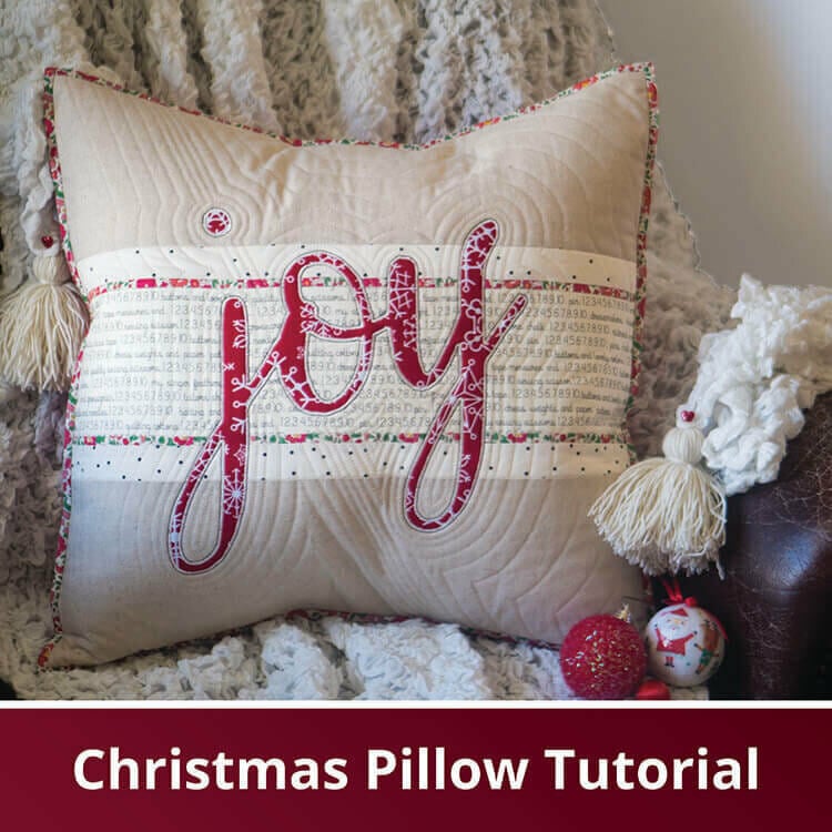 Beautiful throw pillow with the word "joy" sewn on the front