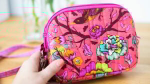 Colorful floral patterned handbag in hand