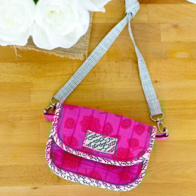 Colorful handmade clutch bag on table