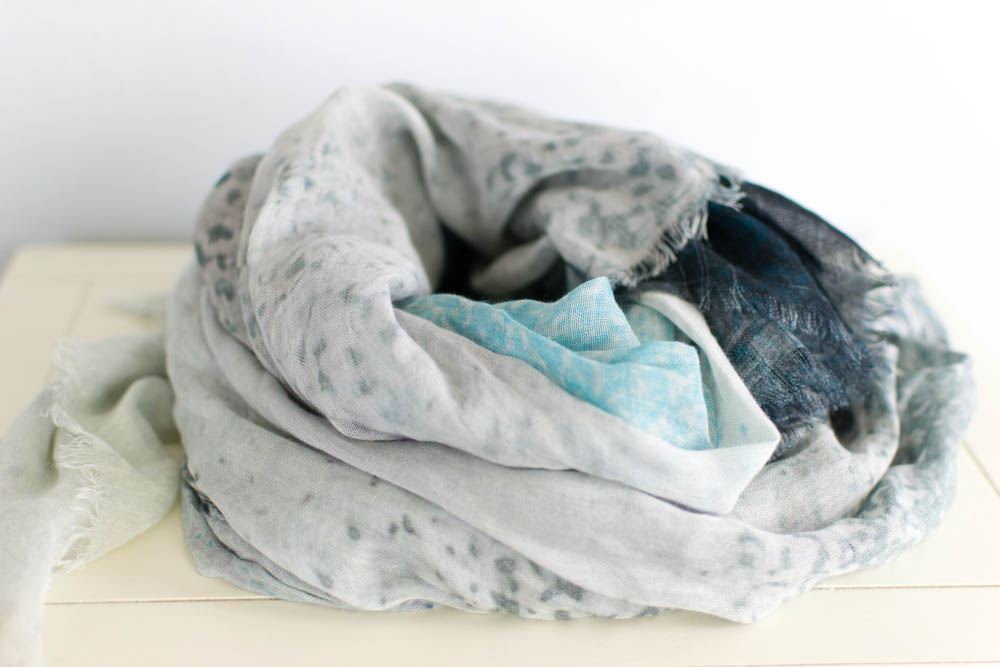 Soft, patterned scarf in a pile.