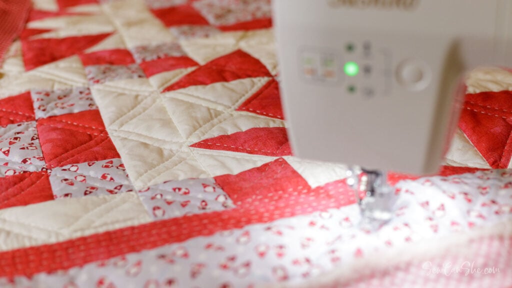 Sewing machine on red quilt fabric