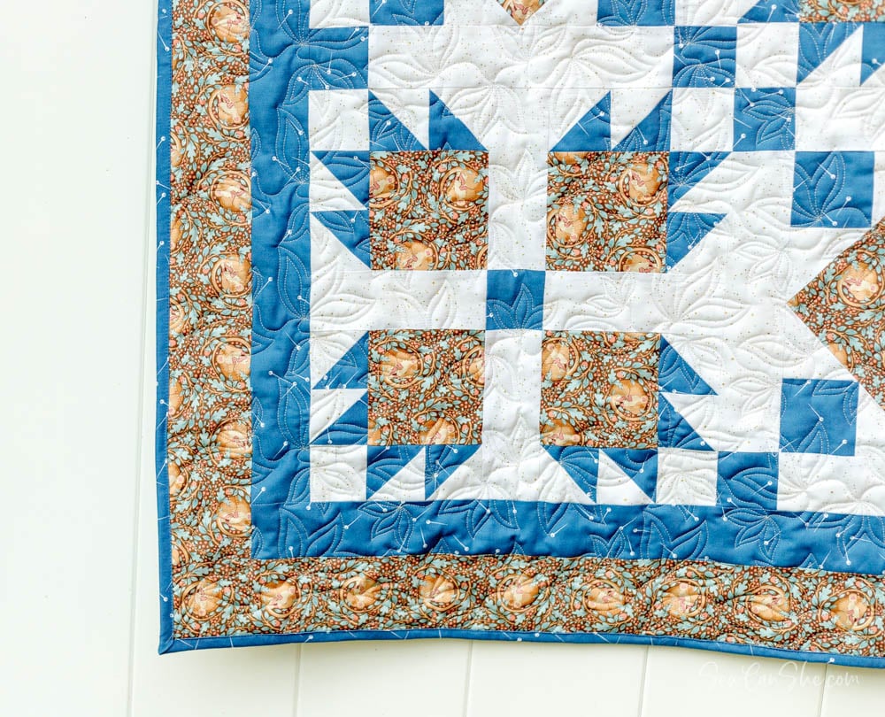 Colorful quilt with bear paw pattern.