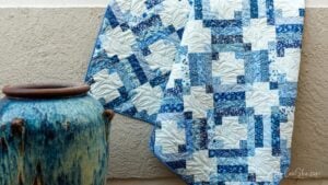 Blue quilt draped over pottery