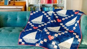 Dark blue quilt with sailboats, Irish chain, and hearts