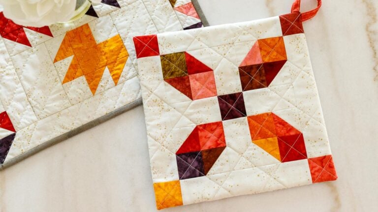 Colorful quilted pot holder design in warm colors