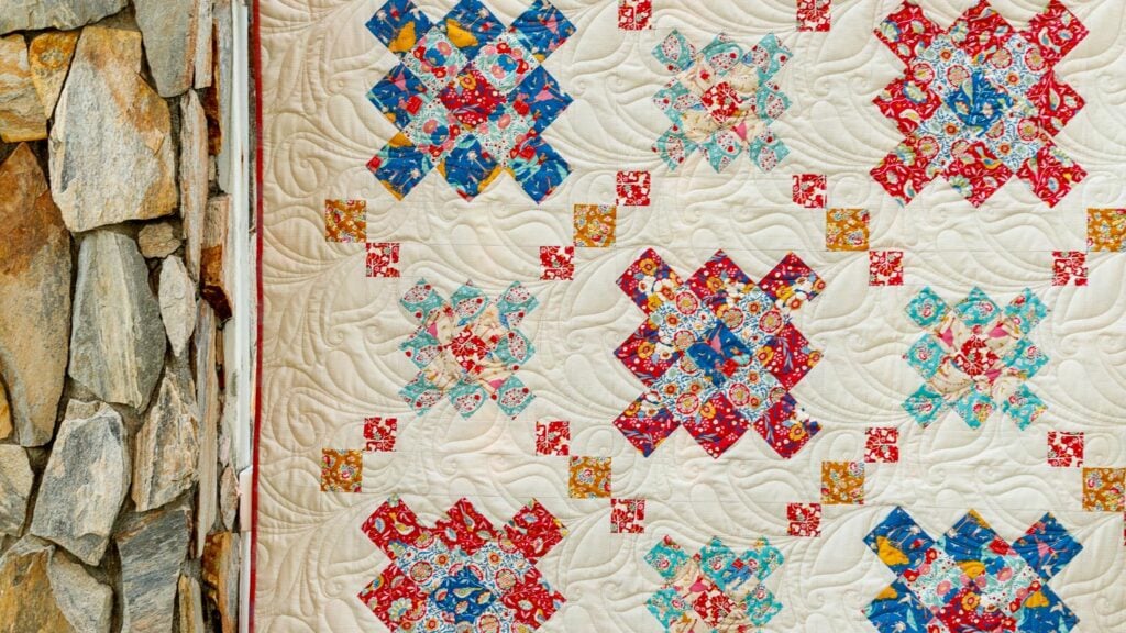 closeup of granny square quilt on fence