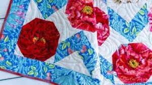 Colorful floral quilt with geometric patterns