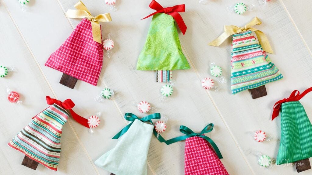 Colorful fabric Christmas trees with candies