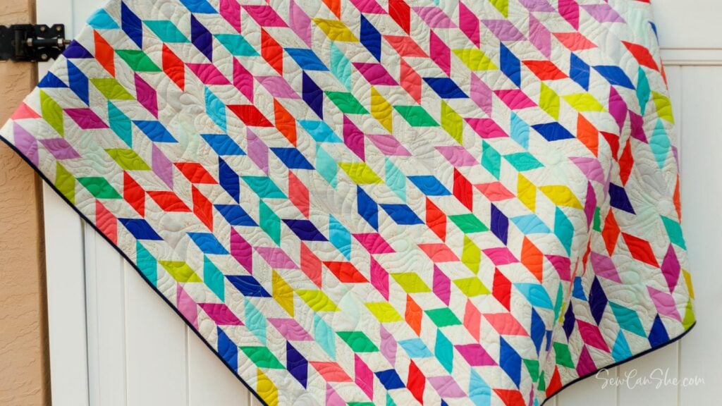 Colorful quilt hanging on door