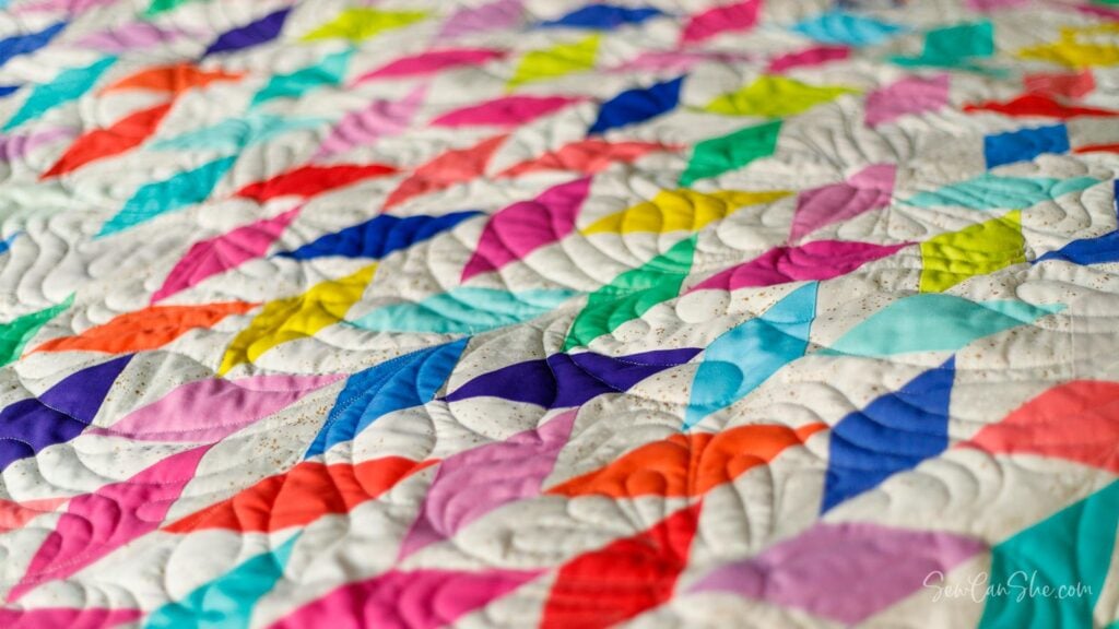 Colorful jelly roll strip quilt with geometric patterns