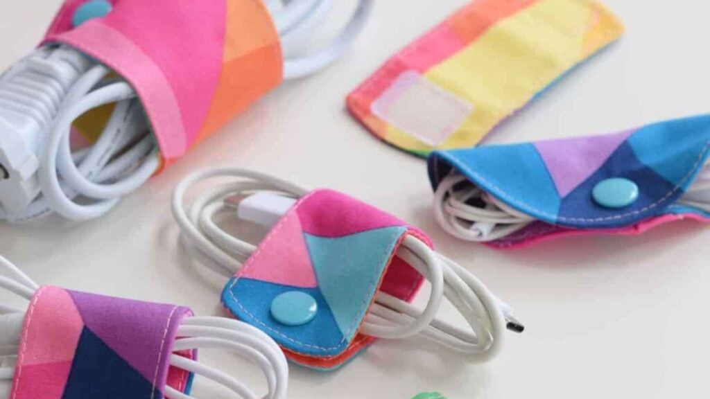 Colorful fabric pieces with a snap closure used for keeping cables orderly.