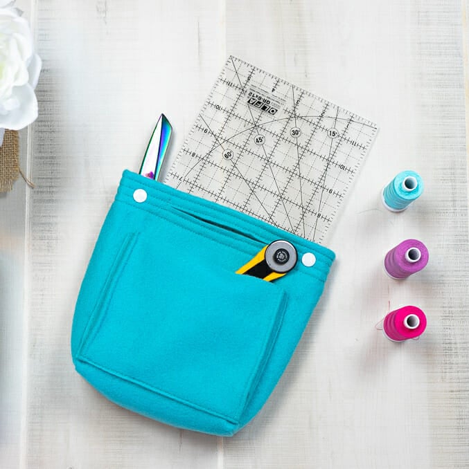 blue felt purse organizer holding sewing tools and notions.