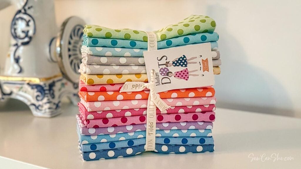 Colorful polka dot fabric fat quarter bundle stacked.