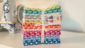 Colorful polka dot fabric fat quarter bundle stacked.