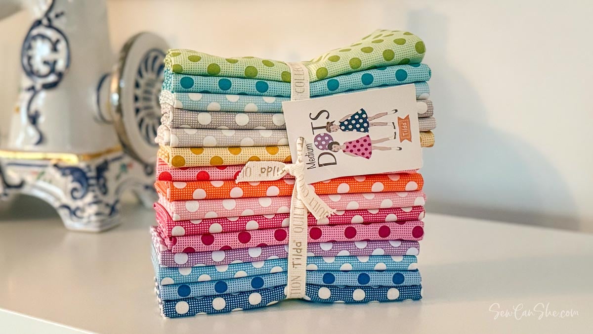 Colorful polka dot fabric fat quarter bundle stacked.