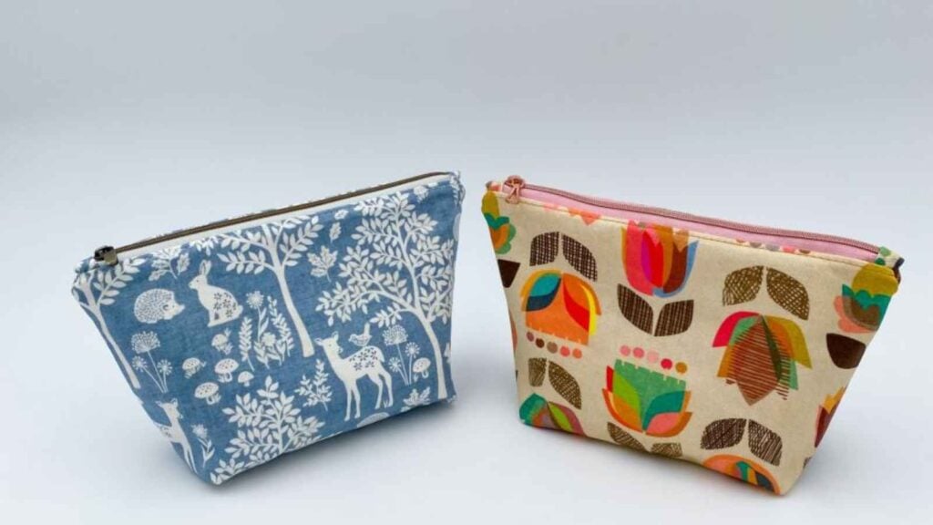 Two wide-bottom zipper pouches sewn with delightful cotton fabric designs demonstrating an aesthetic organization solution