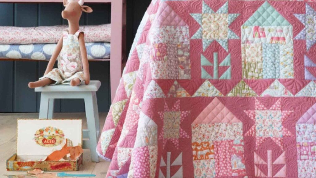 A "Modern Traditional" quilt featuring a series of stylized house blocks arranged in a clean, repeating grid. The houses are pieced with soft Tilda florals and set against a crisp, neutral background, creating a sophisticated heritage look that is perfect for a Grandmillennial bedroom.