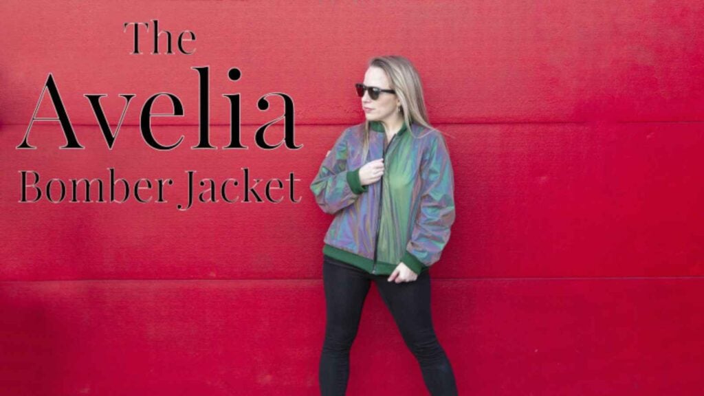 Woman modeling a reflective fabric bomber jacket from the 80s