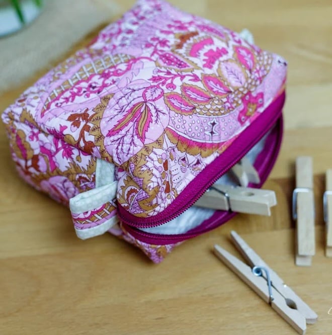zipper pouch with clothes pins spilling out.