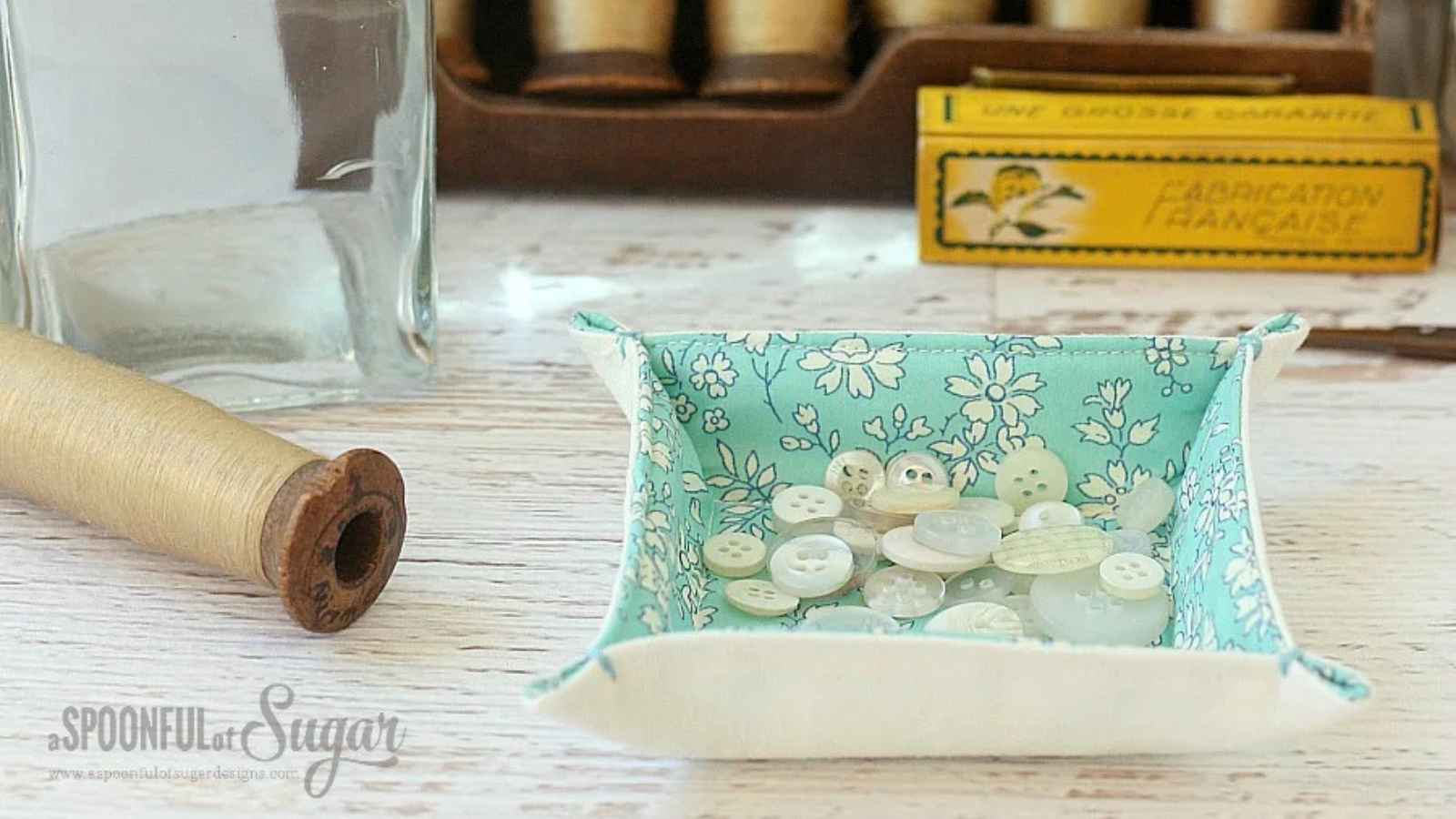 Pretty handsewn fabric tray holding buttons