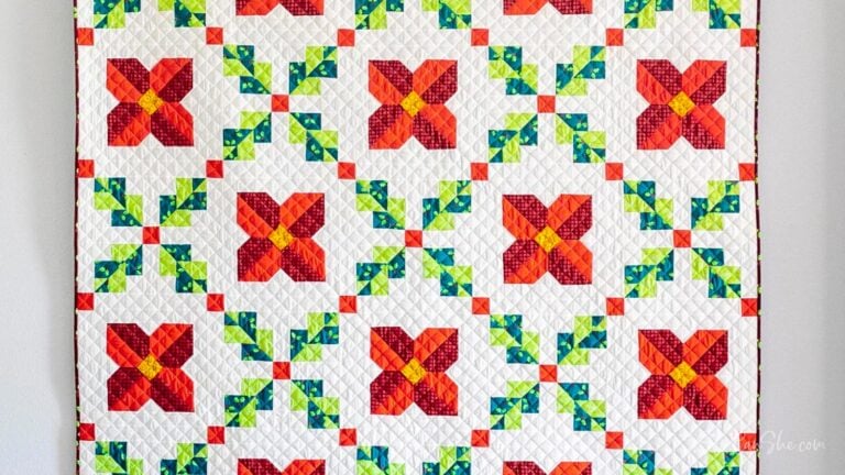 Colorful Christmas quilt with floral patterns.