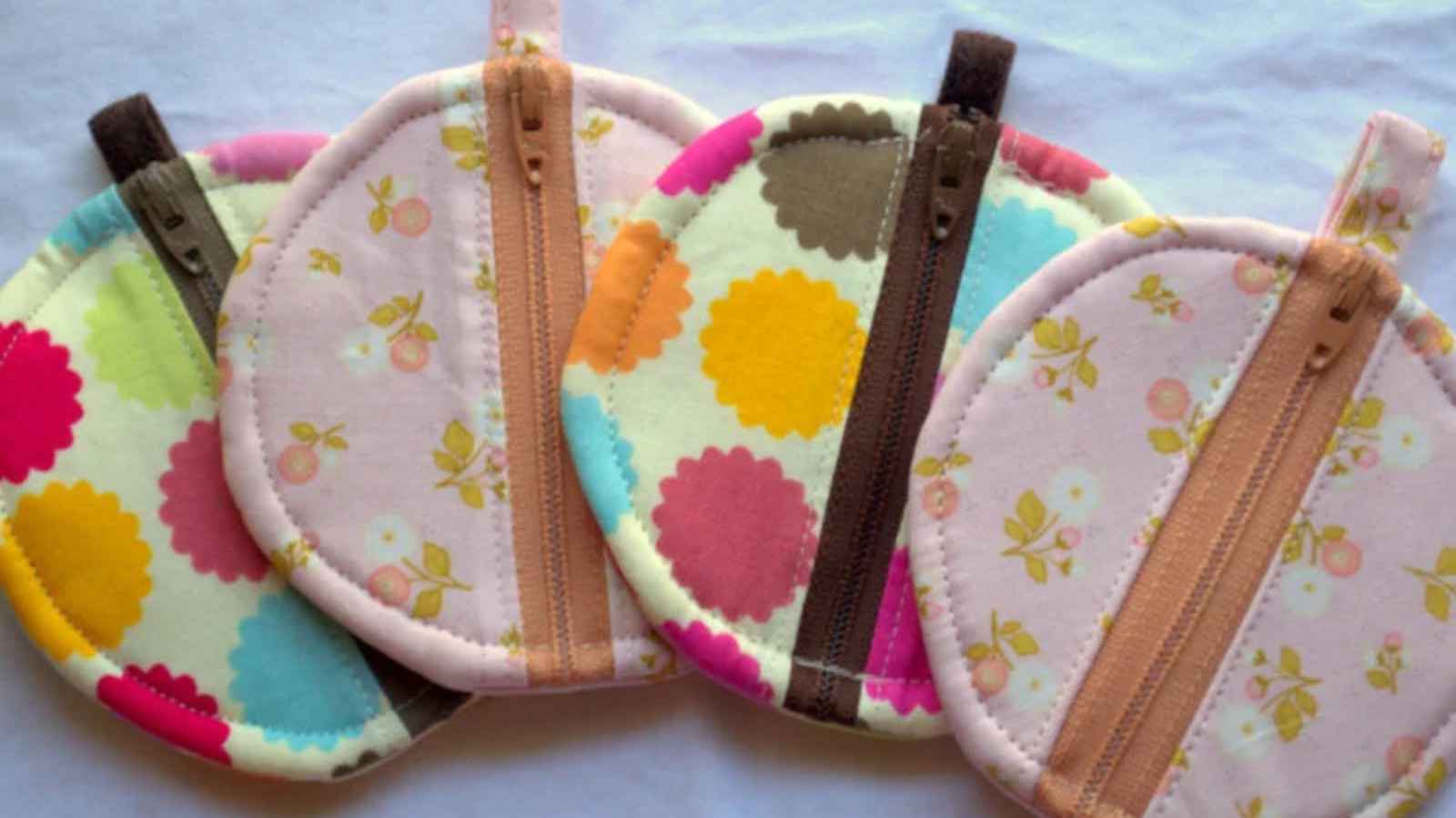 Four colorful circular zipper pouches