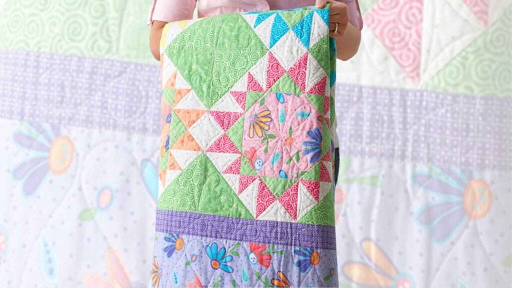 Brightly colored spring quilt with lots of small pieces perfect for scrap buster projects.