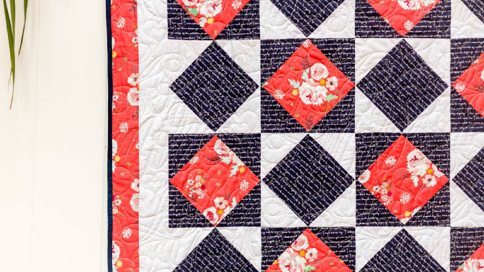 diamond in a square quilt hanging on a fence