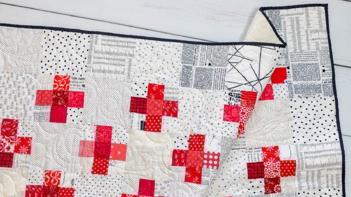 Colorful quilt with red plus signs design