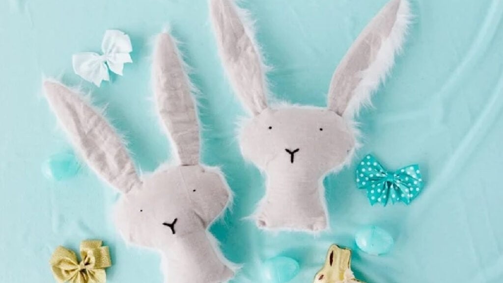 Two stuffed bunnies with decorations.