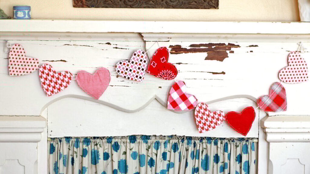 heart garland displayed on a fireplace showing a valentine idea