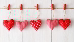 A vibrant collection of handmade Valentine's crafts including a fabric garland and heart-shaped gifts. A brilliant DIY Valentine project list for a last-minute home reset.