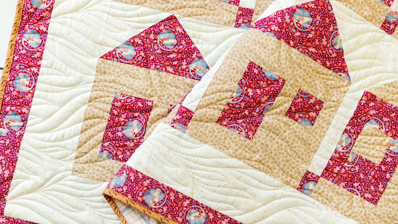 Colorful 3 yard quilt with house patterns.