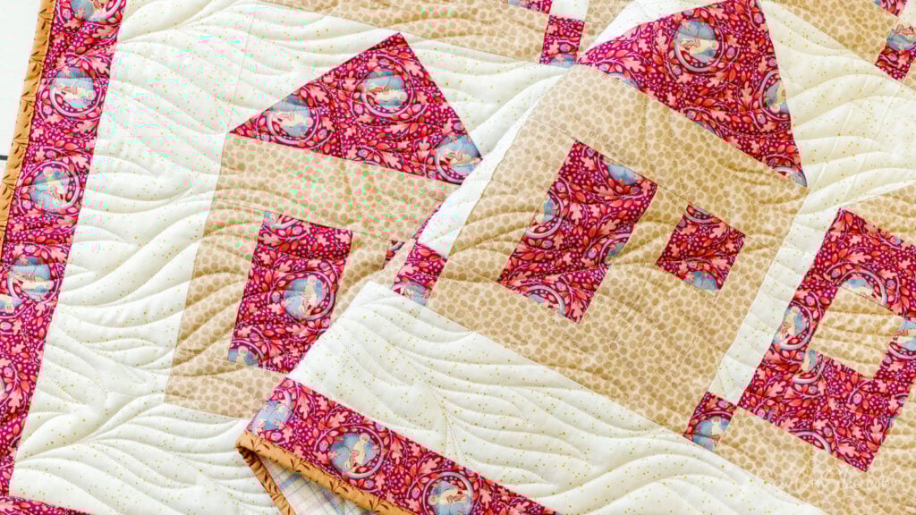 Colorful quilt with house patterns.