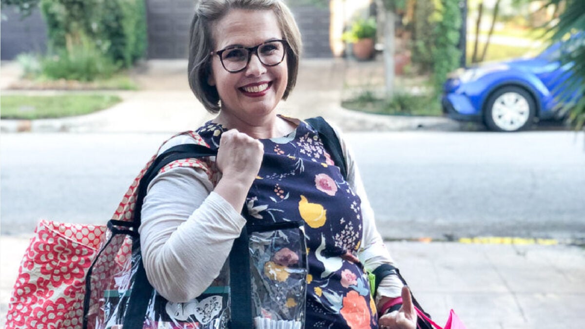 Caroline carrying colorful market bags.