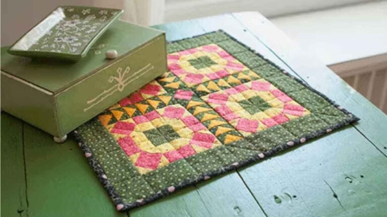 Colorful mini quilt on green table