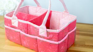 Pink sewing caddy with compartments.