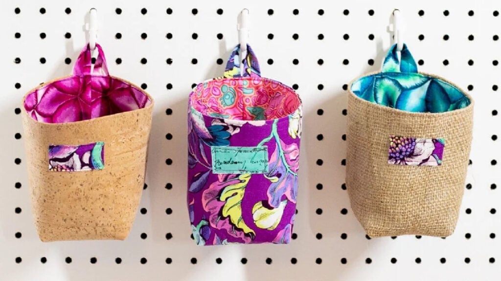 Three hand sewn hanging organizer baskets