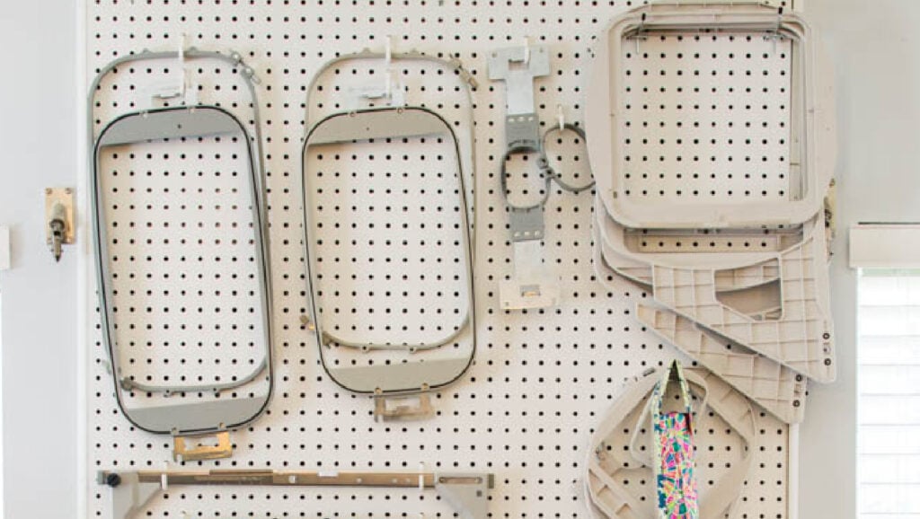 In the hoop embroidery guides hanging on a pegboard