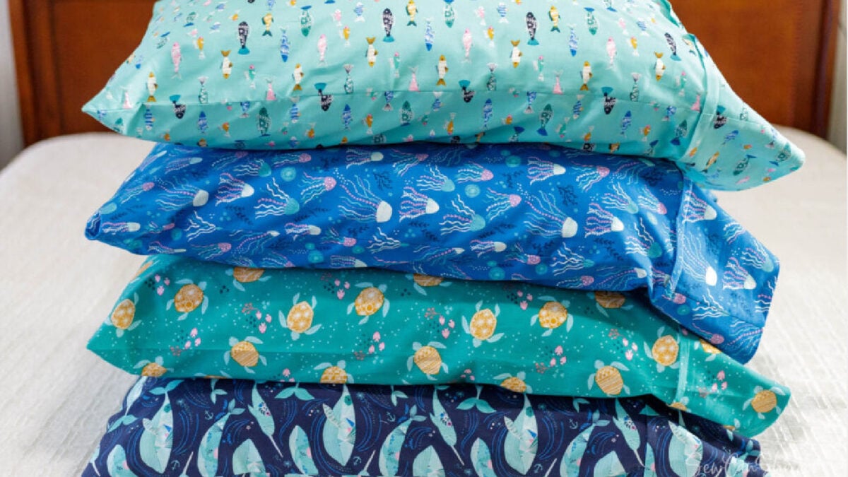 Stacked pillows on a bed from one yard fabric