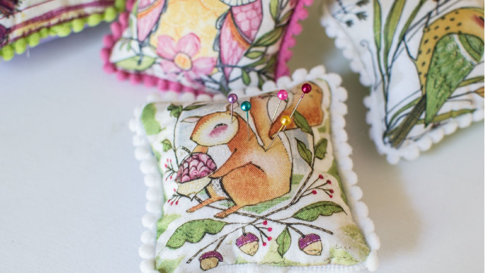 Colorful decorative pincushions with pins