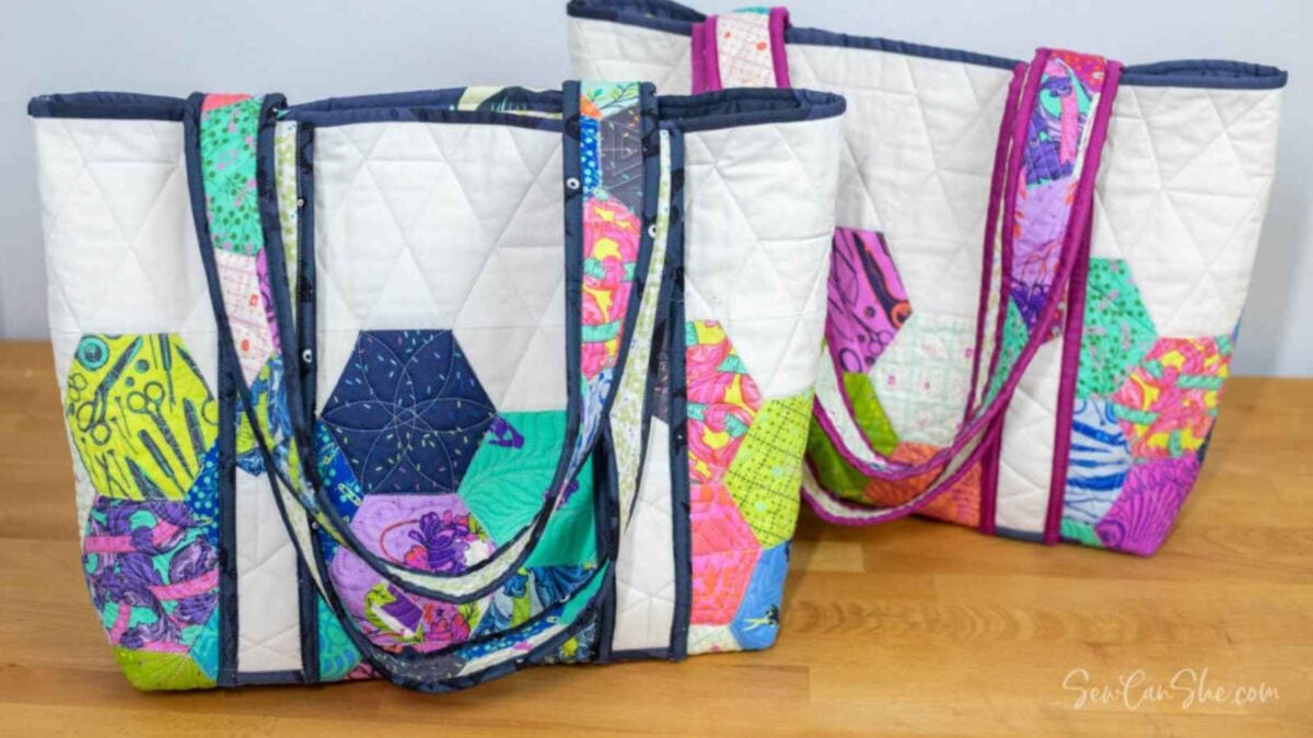 Colorful quilted tote bags displayed together.