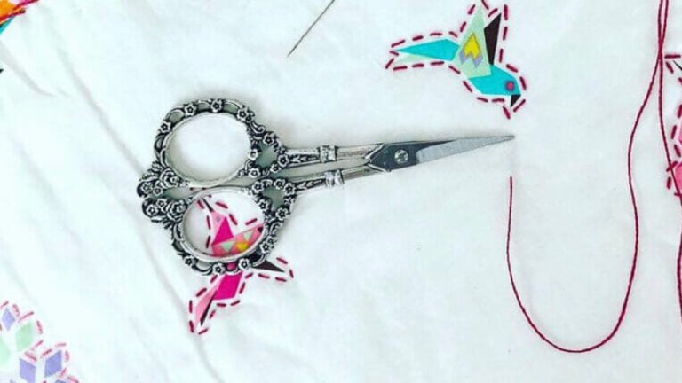 Decorative scissors on embroidered fabric