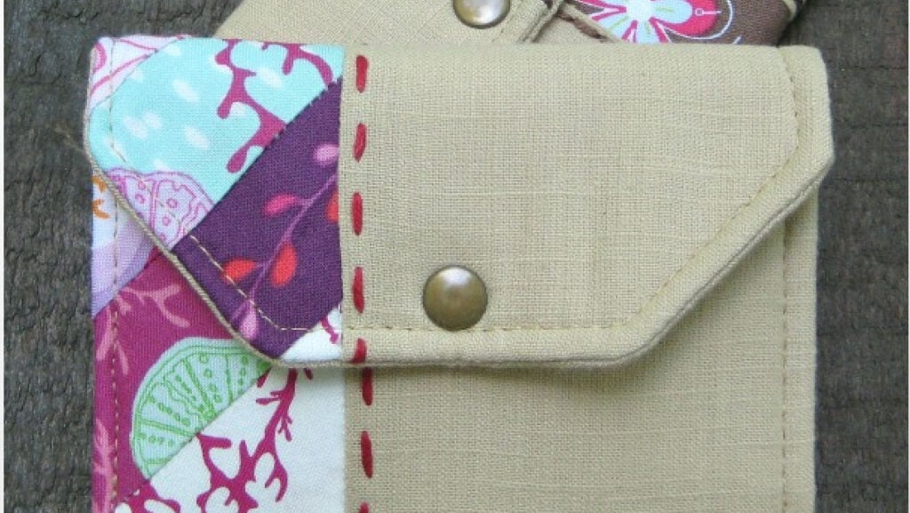 handsewn wallet from textured fabric with a modern asymmetrical scrappy section down the side.