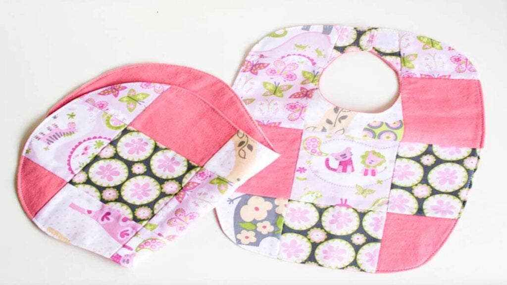 patchwork bib and burp cloth set sewn in pink shades of fabric