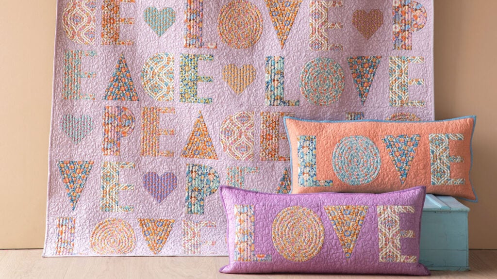 Colorful quilt and pillows with words Love and Peace