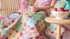Colorful free quilt patterns with person holding cup by Tilda