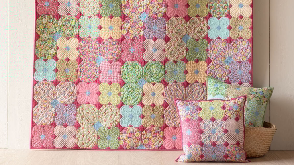 Colorful floral quilt with matching pillows