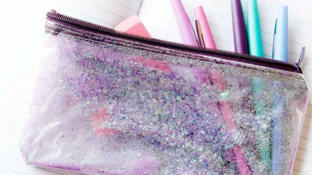 Glittery pencil pouch with colorful pens.